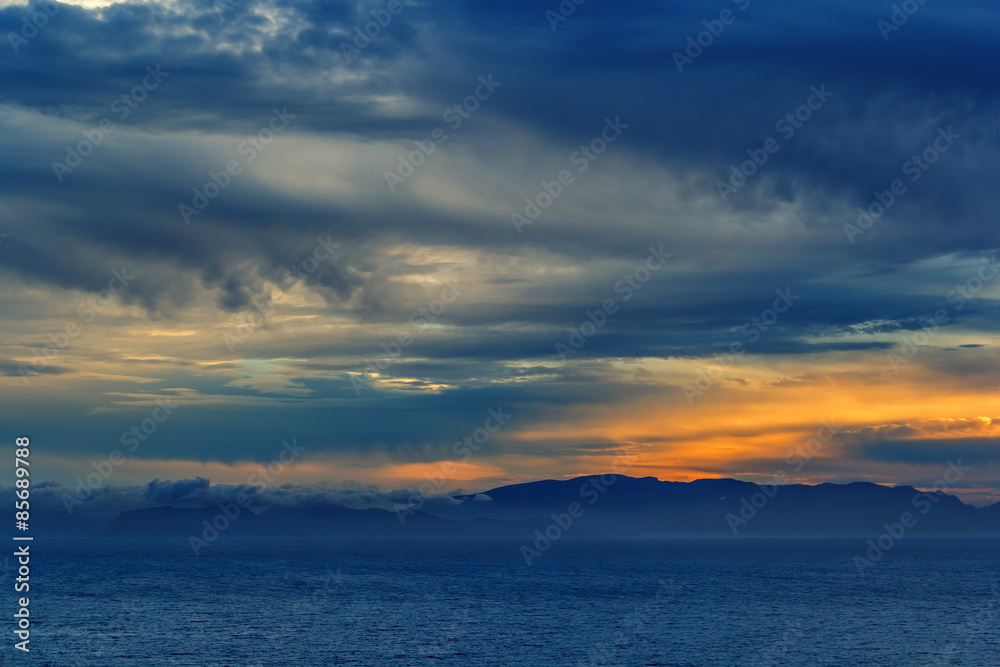 sunset over the sea with a storm approaching