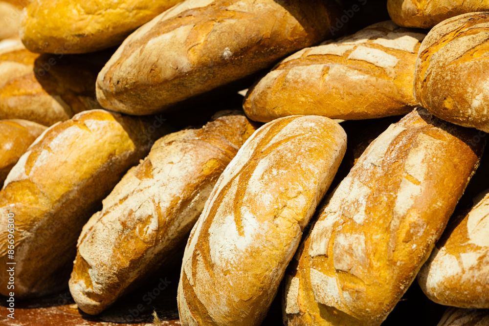 many brown rustic fresh rye bread loaves