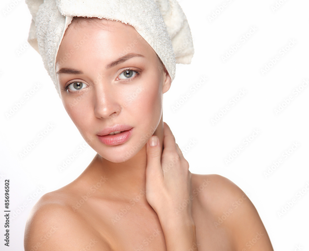 Portrait of beautiful girl touching her face with a towel on