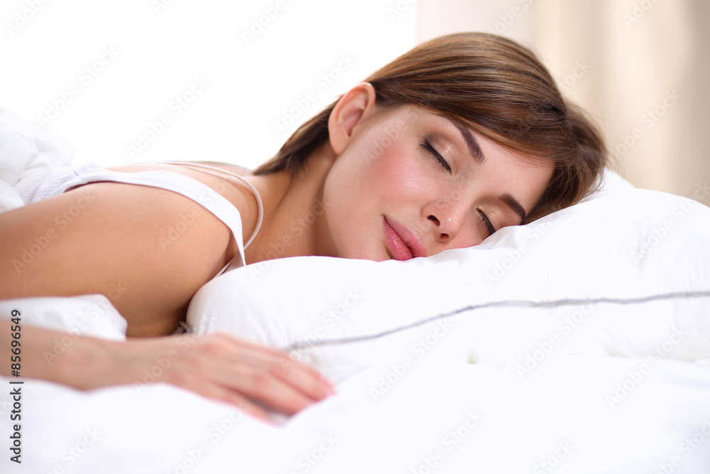 Beautiful girl sleeps in the bedroom, lying on bed Beautiful girl sleeps in the bedroom, lying on bed