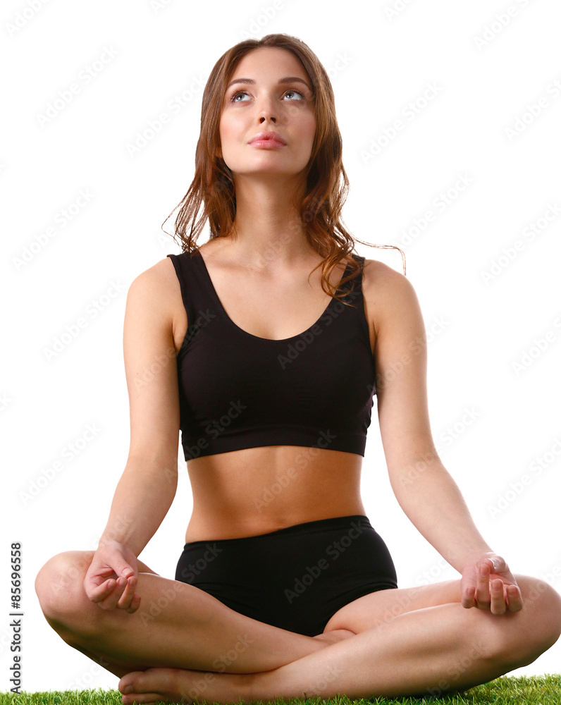 Young woman practicing yoga in the lotus position Young woman practicing yoga in the lotus position