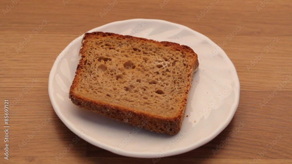 Male hand with slice of rye bread on plate. Full HD Male hand with slice of rye bread on plate. Full HD