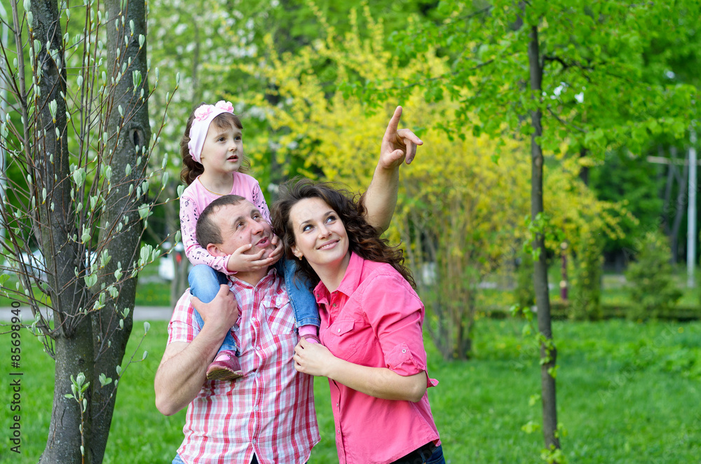 happy family plays a parka with a child