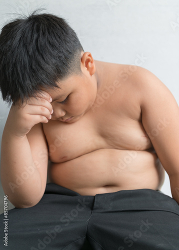 Asian cute fat boy strained themselves overweight.