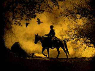 A dramatic design of a cowboy and his horse riding in a meadow into the sunset with crows flying above.  A mixed media piece of artwork in photography and watercolor.