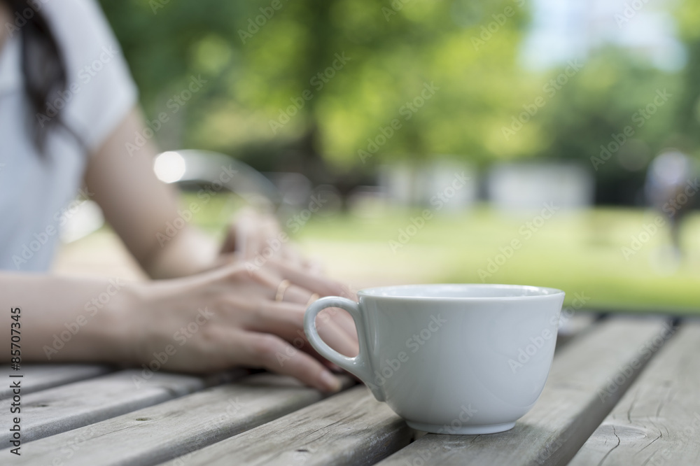 Women are relaxing with a cup of coffee in the garden Women are relaxing with a cup of coffee in the garden