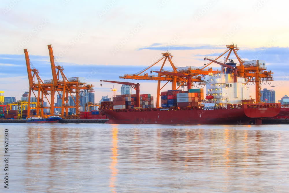 Working crane loading bridge in shipyard at dusk for Logistic Import Export background