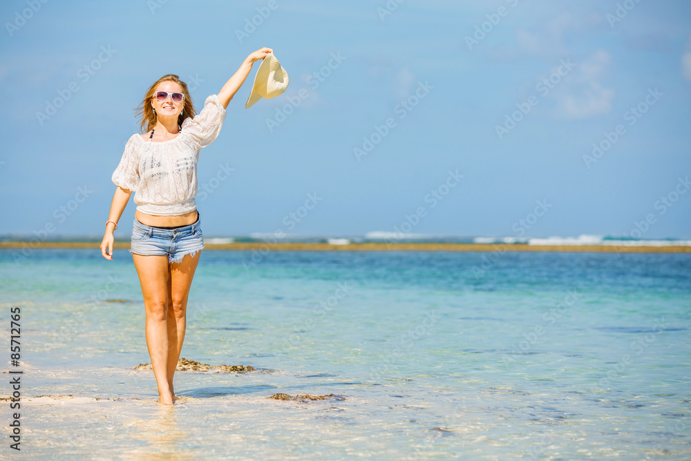 Young skinny caucasian girl at the beach waving with white hat Young skinny caucasian girl at the beach waving with white hat