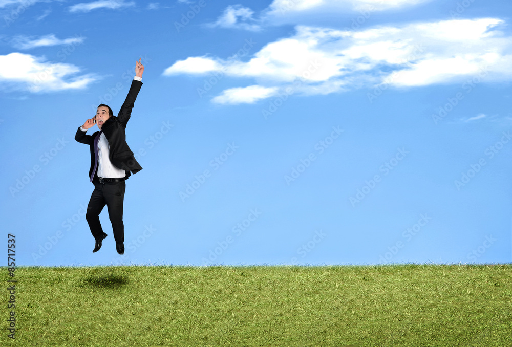 Business man jumping in landscape