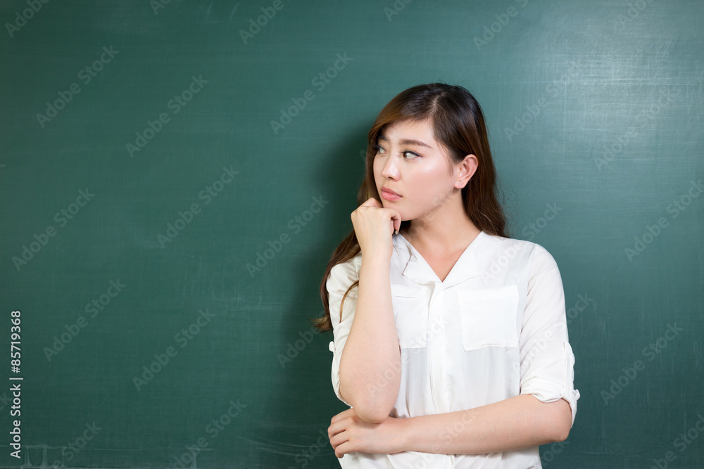 asian beautiful woman thinking in front of blackboard