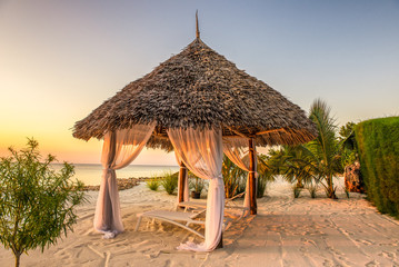 Fototapete Sansibar Strandliegen im Sonnenuntergang auf Sansibar  © Nick Fox