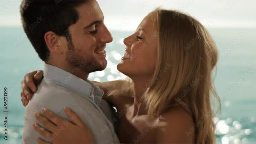 young couple meeting and hugging on beach young couple meeting and hugging on beach
