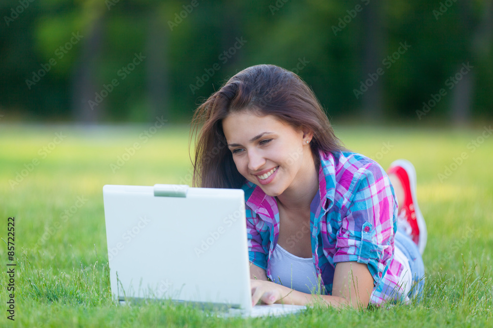 Young teen girl with white laptop computer Young teen girl with white laptop computer