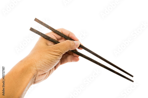 Hand hold chopsticks on white background.