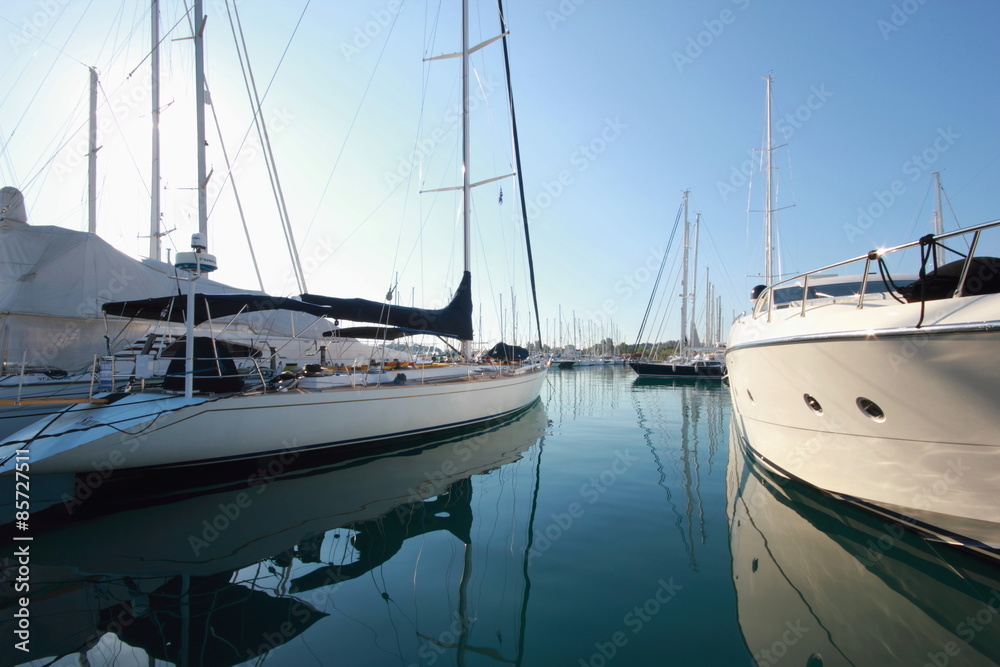 Fototapeta premium reflections of super yachts and motor power boats in a marina 