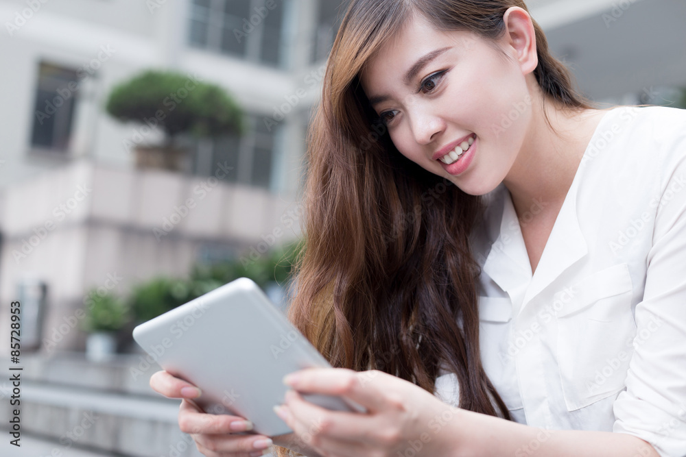 Asian female student using tablet in campus Asian female student using tablet in campus