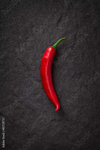 chili pepper on black stone background 