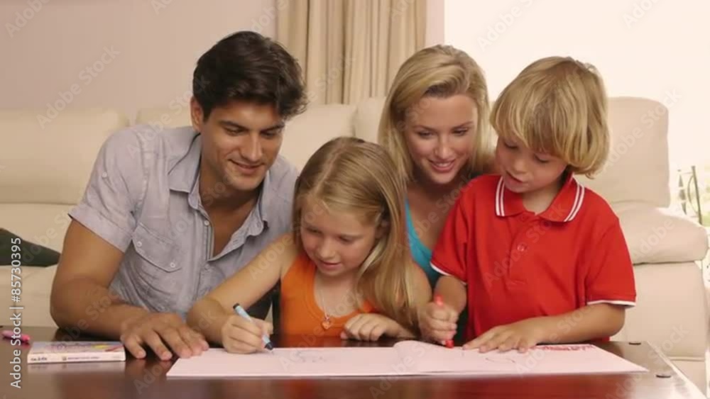 Family drawing and coloring together in living room. Family drawing and coloring together in living room.