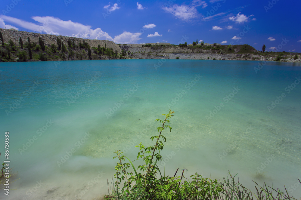 Flooded stone quarry. Crimea. Skalistoe village, Bakhchisaray region. Lake in quarry.