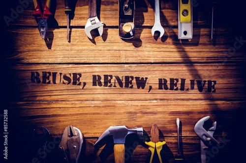 Картината върху платно Reuse, renew, relive against desk with tools