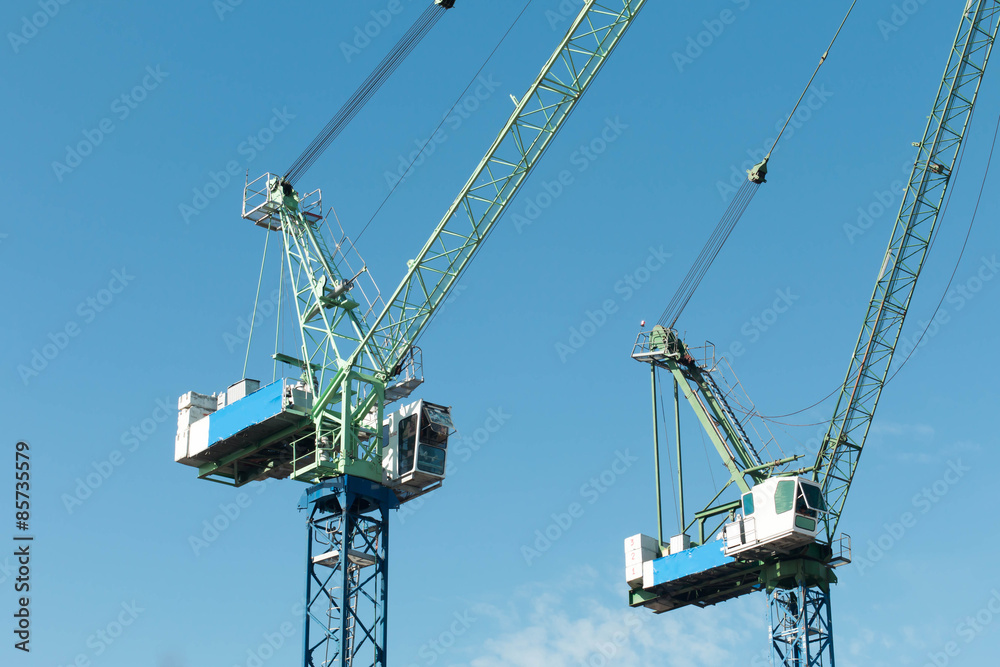 Construction site with cranes on sky background Construction site with cranes on sky background