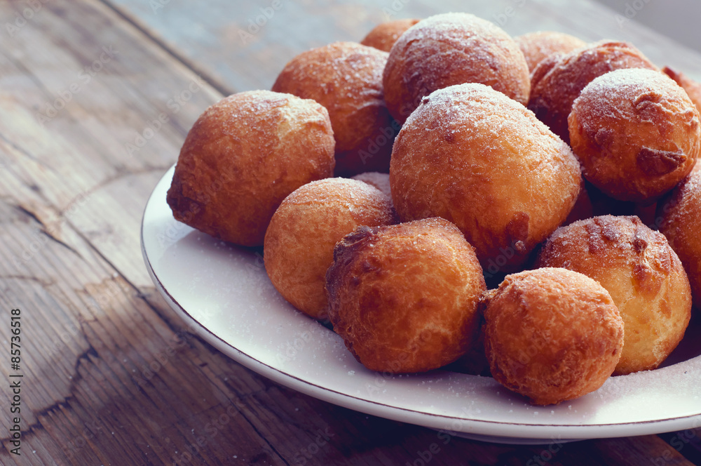 Sweet fried doughnuts sprinkled with sugar powder Sweet fried doughnuts sprinkled with sugar powder