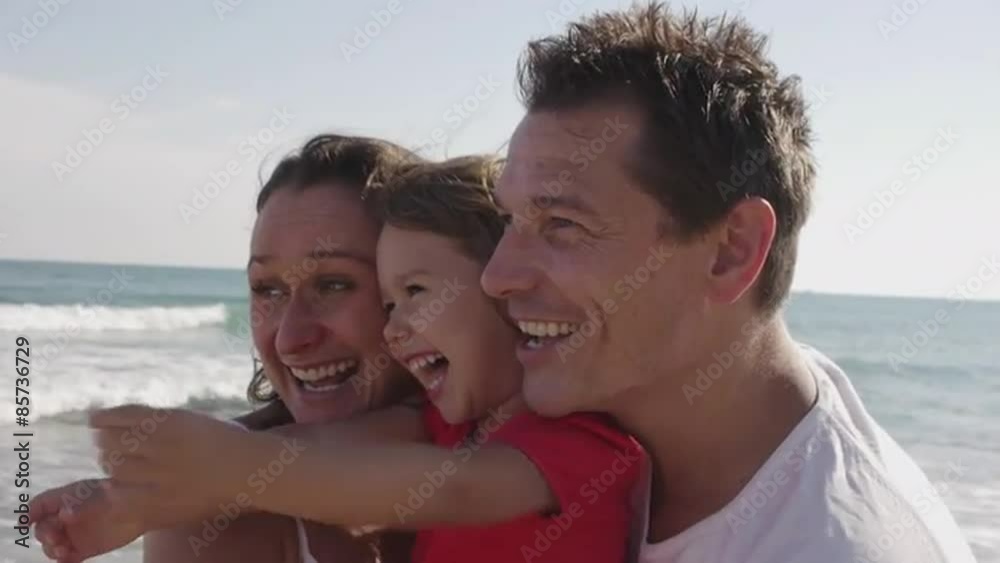 Happy family hugging together at the beach.