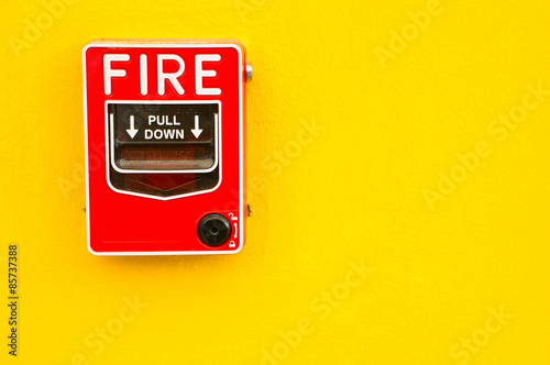 Fire alarm switch on yellow wall