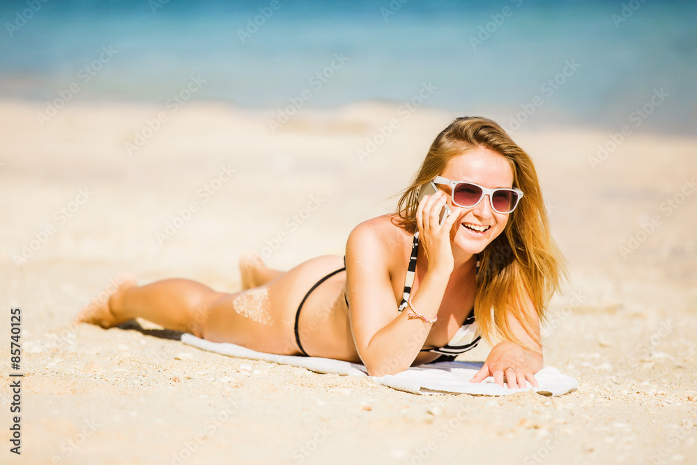 Sexy young blond girl in sunglasses speaking on the phone Sexy young blond girl in sunglasses speaking on the phone
