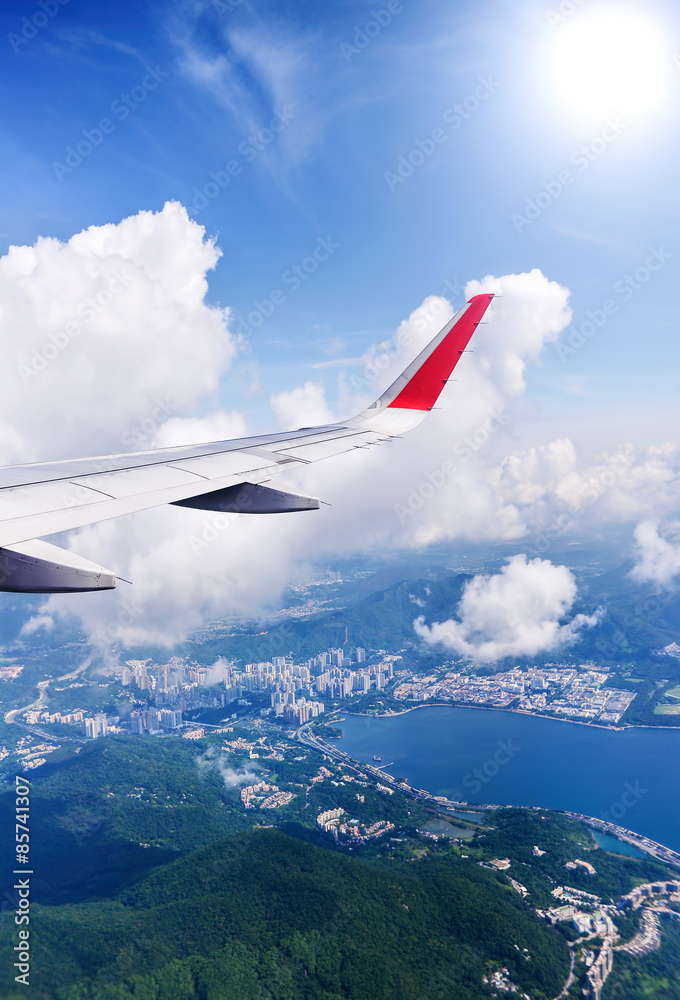Fototapeta premium Wing of an airplane flying in the sky