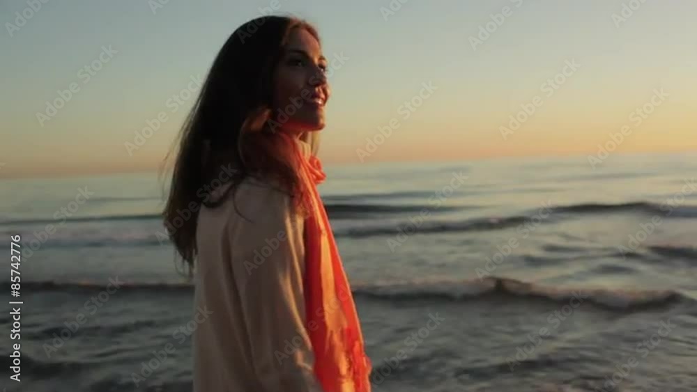 Woman walking on beach in sunset. Woman walking on beach in sunset.