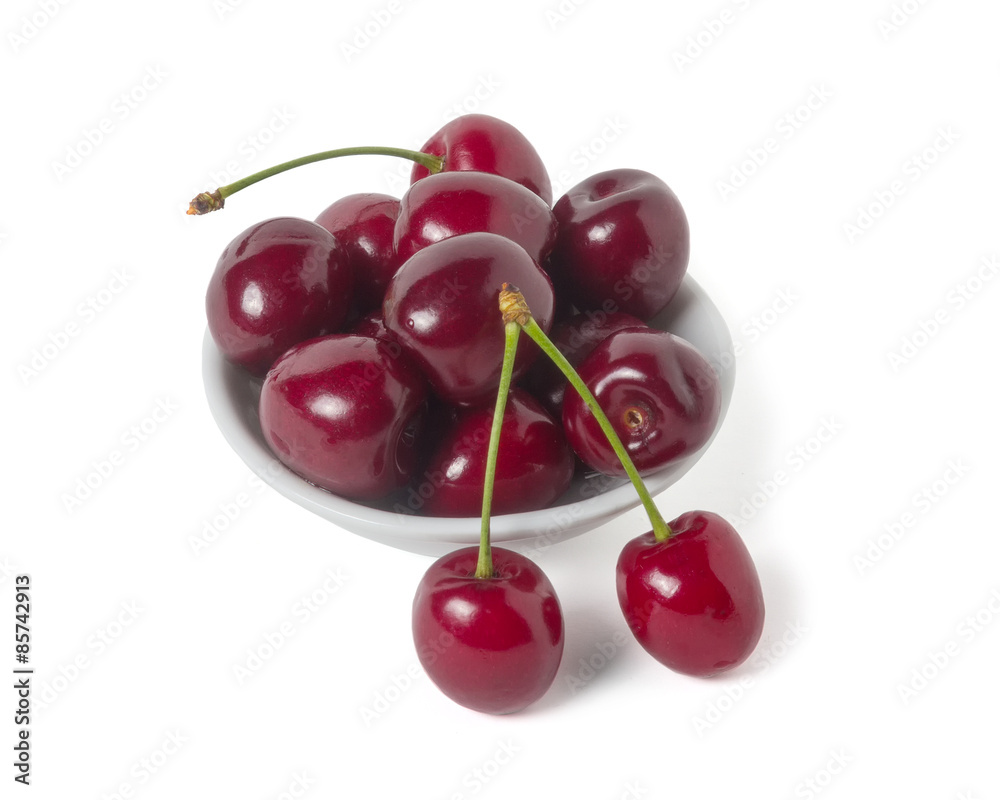 Ripe cherry on a saucer. Isolated on white background Ripe cherry on a saucer. Isolated on white background