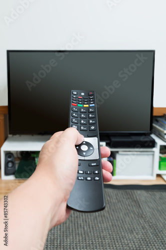 Hand holding and pointing remote control