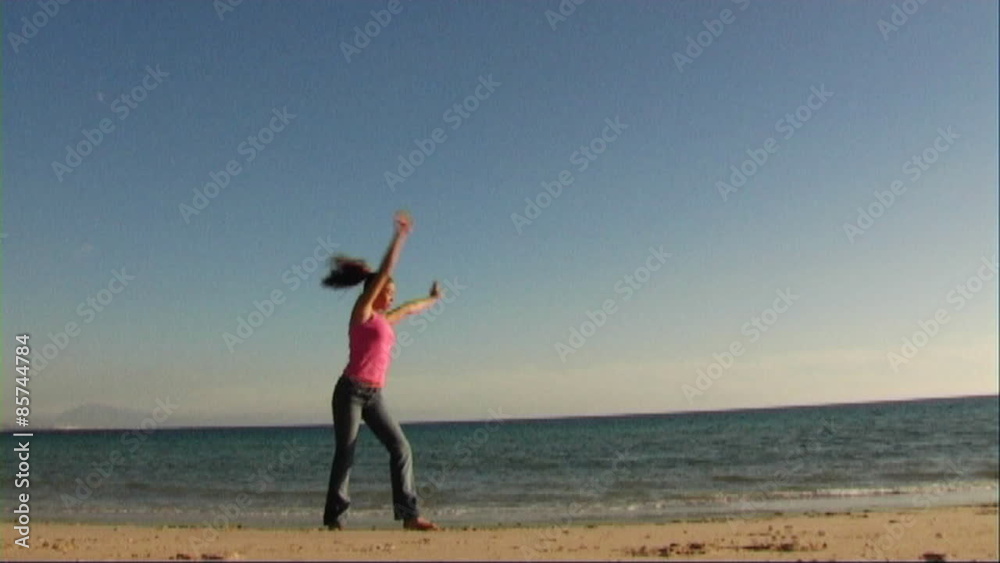 Woman on beach doing acrobatics
