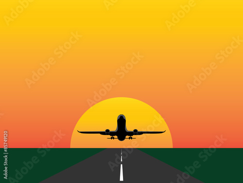 Plane silhouette over the sun, taking off or landing.Concept:Travelling,flying,holidays