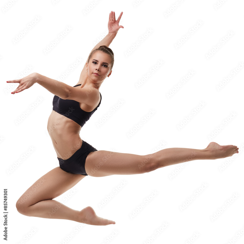 Beautiful female dancer posing in graceful jump Beautiful female dancer posing in graceful jump