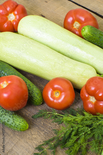 fresh vegetables, squash, cucumbers, tomatoes and fennel on wooden background