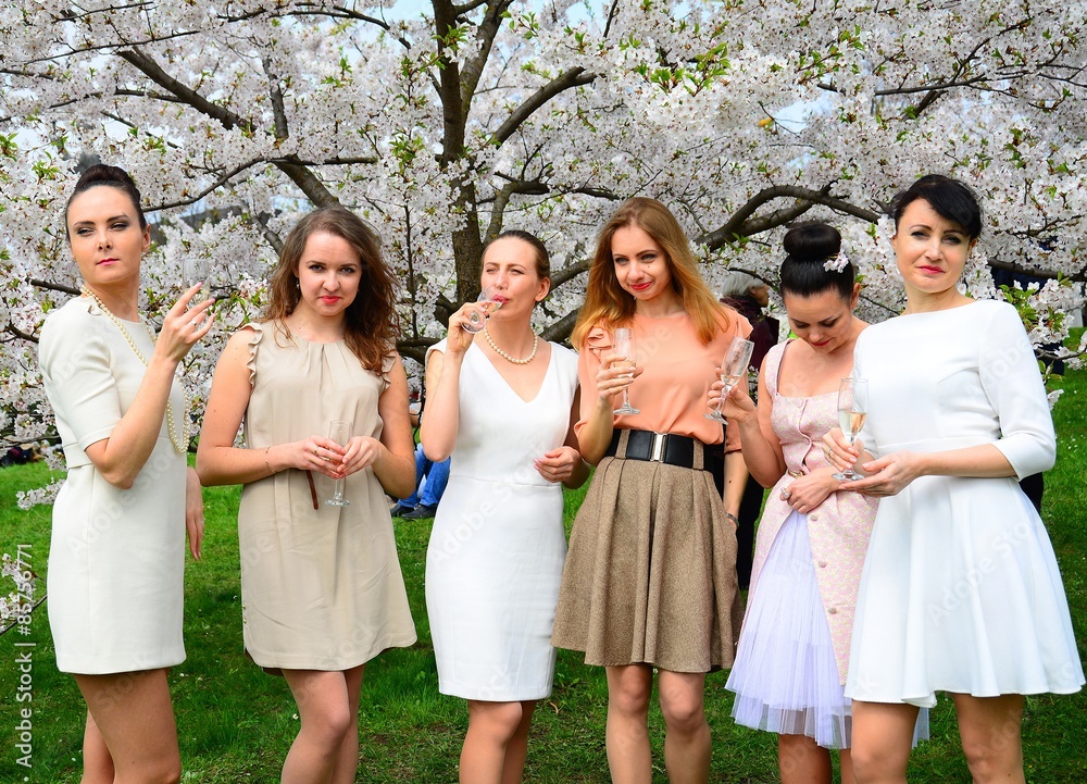 Girls with champagne celebrating in sakura's garden. Girls with champagne celebrating in sakura's garden.
