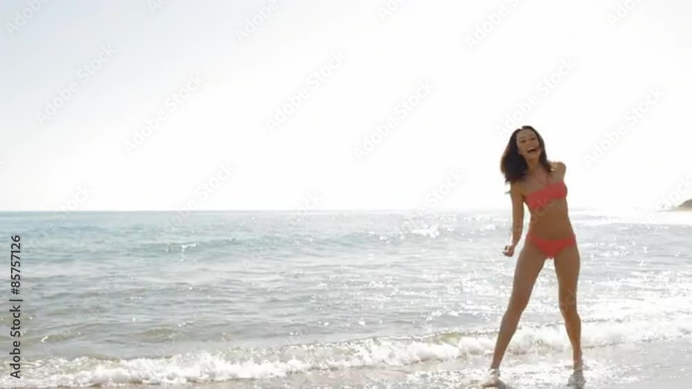 pan shot of young woman running on beach pan shot of young woman running on beach