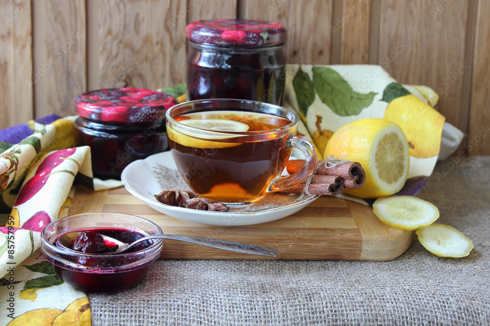 Plate with cherry jam and a cup of tea.. Plate with cherry jam and a cup of tea..