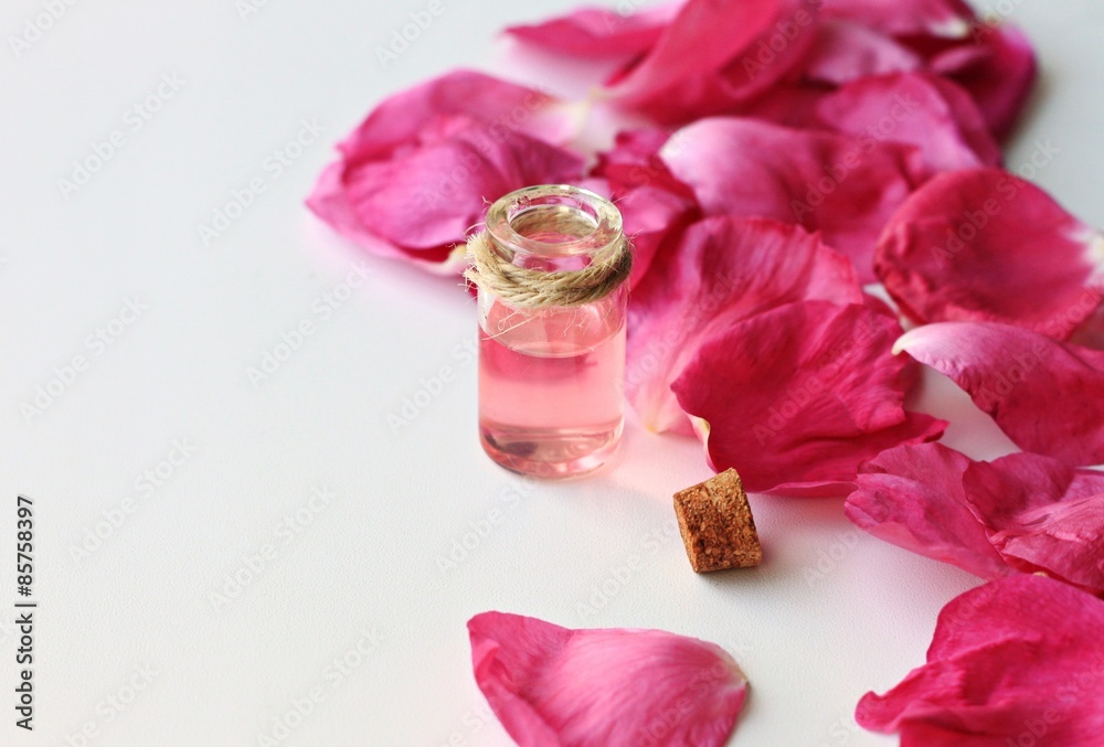 uncorked open vial pink aromatic fluid oil rose petals, anti-stress treatment with essential oils uncorked open vial pink aromatic fluid oil rose petals, anti-stress treatment with essential oils