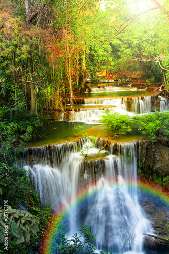 Waterfall in deep forest of Thailand with rainbow.