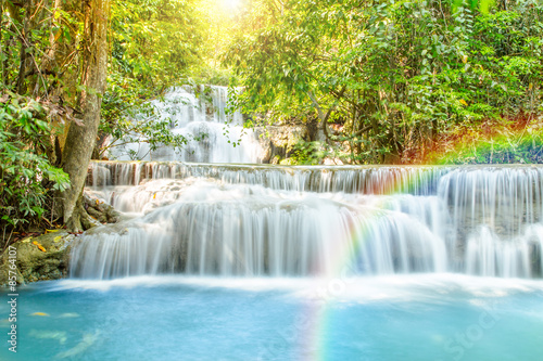 Beautiful waterfall with rainbow in deep forest, Thailand.
