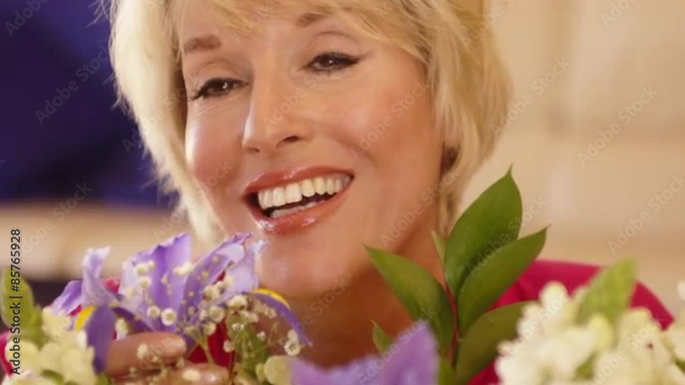 Close up dolly shot of woman smelling flower scent. Close up dolly shot of woman smelling flower scent.
