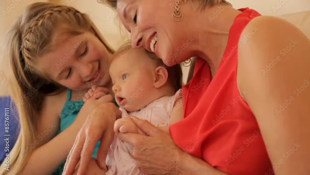 Grandmother and two granddaughters together on sofa. Grandmother and two granddaughters together on sofa.
