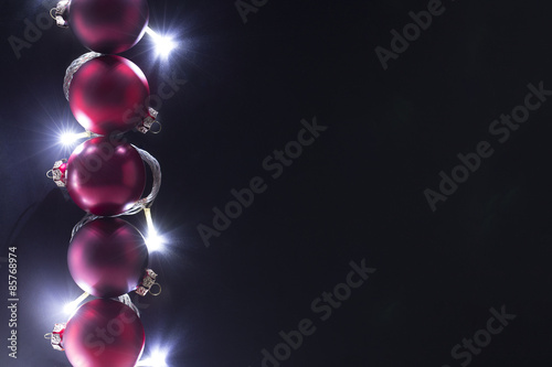 Christmas ball with Christmas light has a space of text in dark background