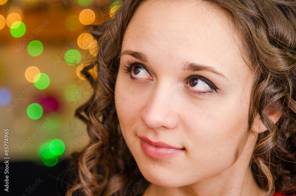 Portrait a young girl on the background of Christmas lights Portrait a young girl on the background of Christmas lights