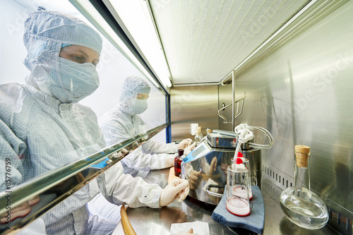 Konstfotografi workers in protective uniform at laboratory