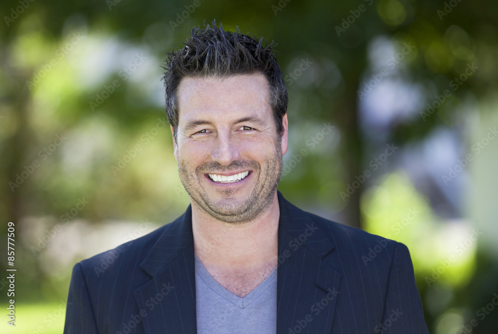 Mature Businessman Smiling At The Camera. He is outside of the office Mature Businessman Smiling At The Camera. He is outside of the office