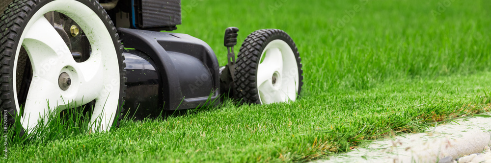 Lawn mower on green lawn. Lawn mower on green lawn.